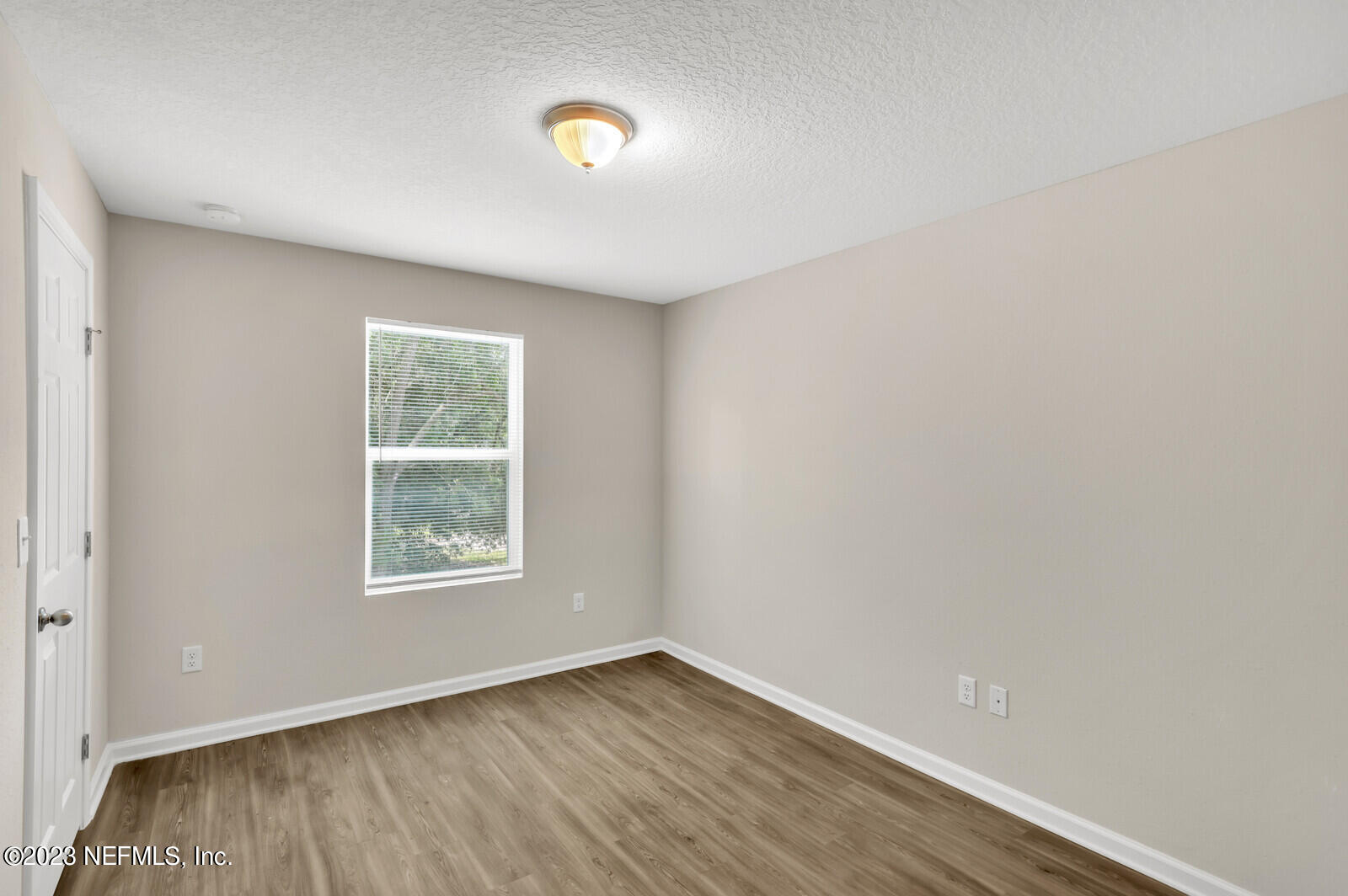 1705 Wright Avenue Jacksonville, FL 32207 - Photo 14 of 22 an empty room with wooden floor and windows