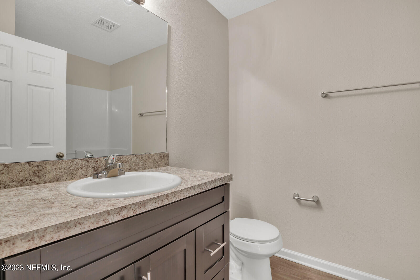 1705 Wright Avenue Jacksonville, FL 32207 - Photo 16 of 22 a bathroom with a granite countertop sink a toilet and a mirror