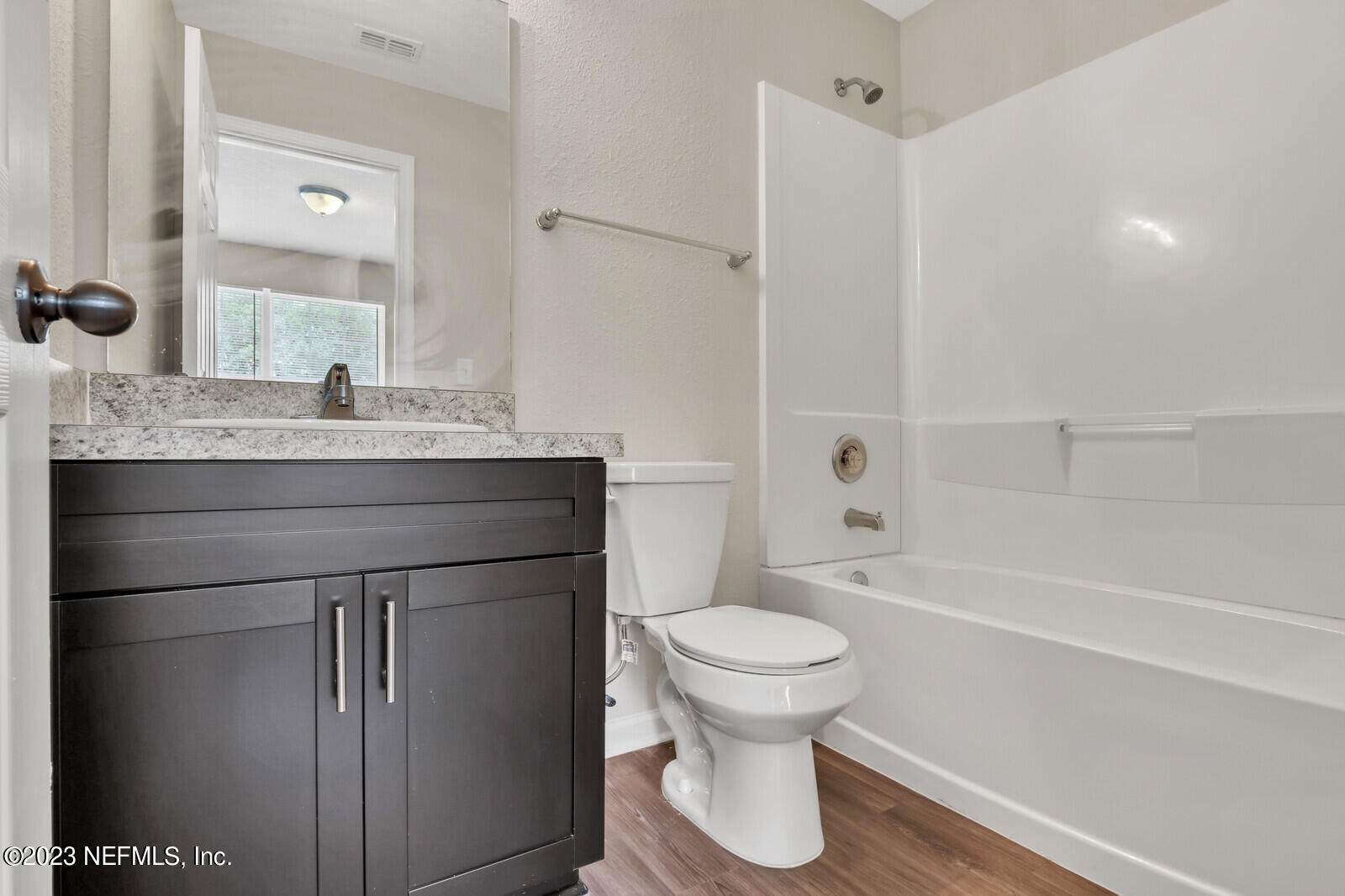 1705 Wright Avenue Jacksonville, FL 32207 - Photo 18 of 22 a bathroom with a granite countertop sink toilet a shower and a mirror