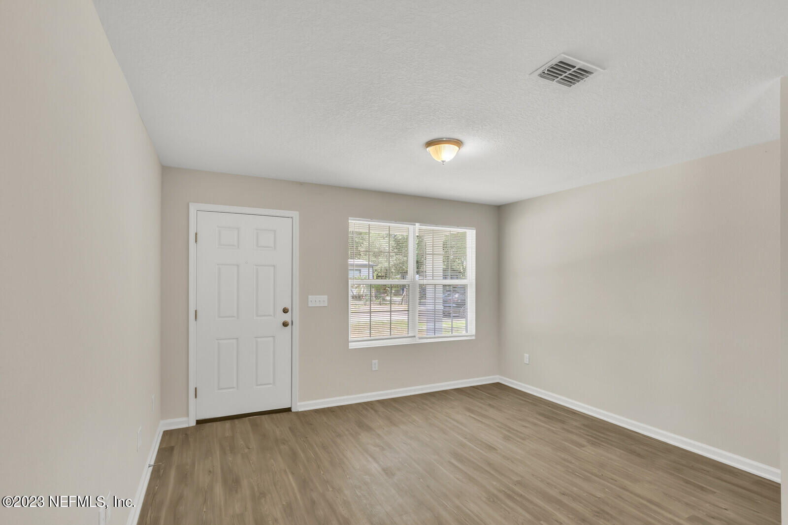 1705 Wright Avenue Jacksonville, FL 32207 - Photo 3 of 22 an empty room with wooden floor and windows