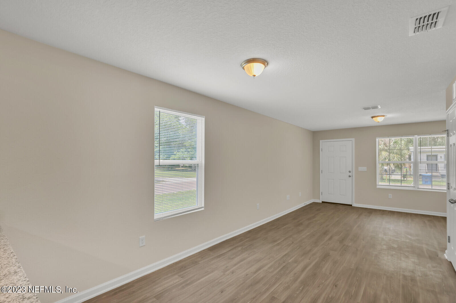 1705 Wright Avenue Jacksonville, FL 32207 - Photo 7 of 22 an empty room with wooden floor and windows