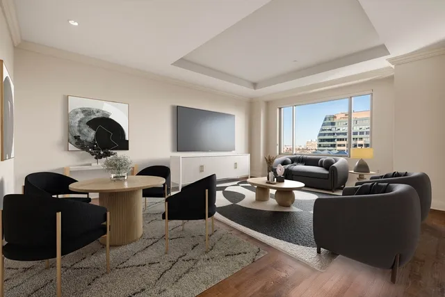 a living room with fireplace furniture and a large window