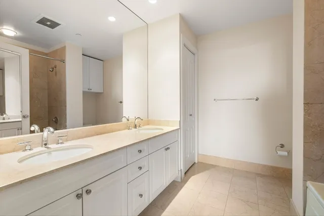a bathroom with a granite countertop sink mirror and double