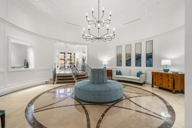 a living room with furniture and a chandelier
