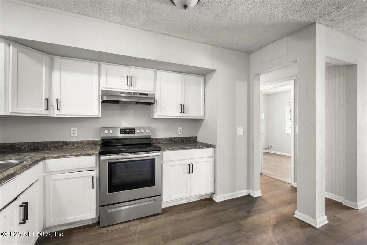 7567 Strato Road Jacksonville, FL 32210 - Photo 12 of 26 a kitchen with stainless steel appliances granite countertop a stove and a refrigerator