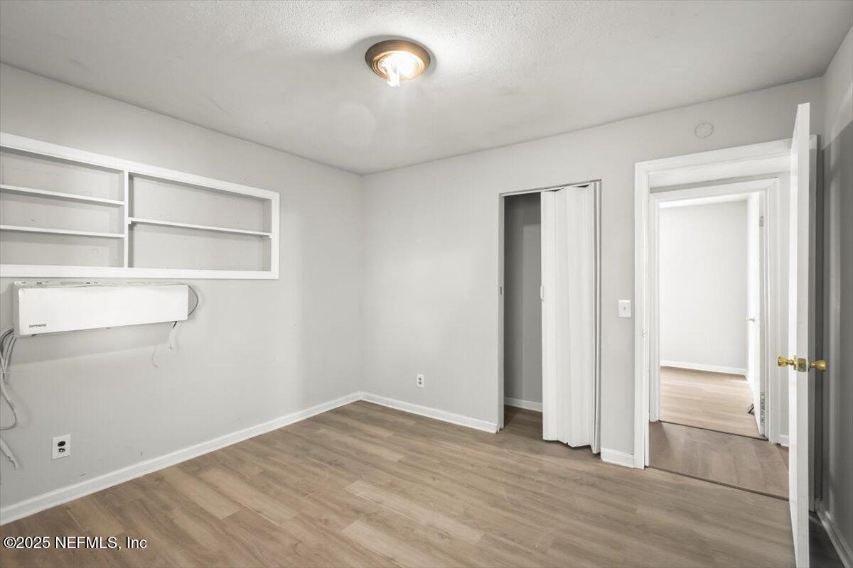 7567 Strato Road Jacksonville, FL 32210 - Photo 20 of 26 an empty room with closet and windows