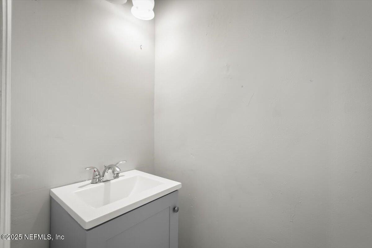 7567 Strato Road Jacksonville, FL 32210 - Photo 21 of 26 a bathroom with a sink and mirror