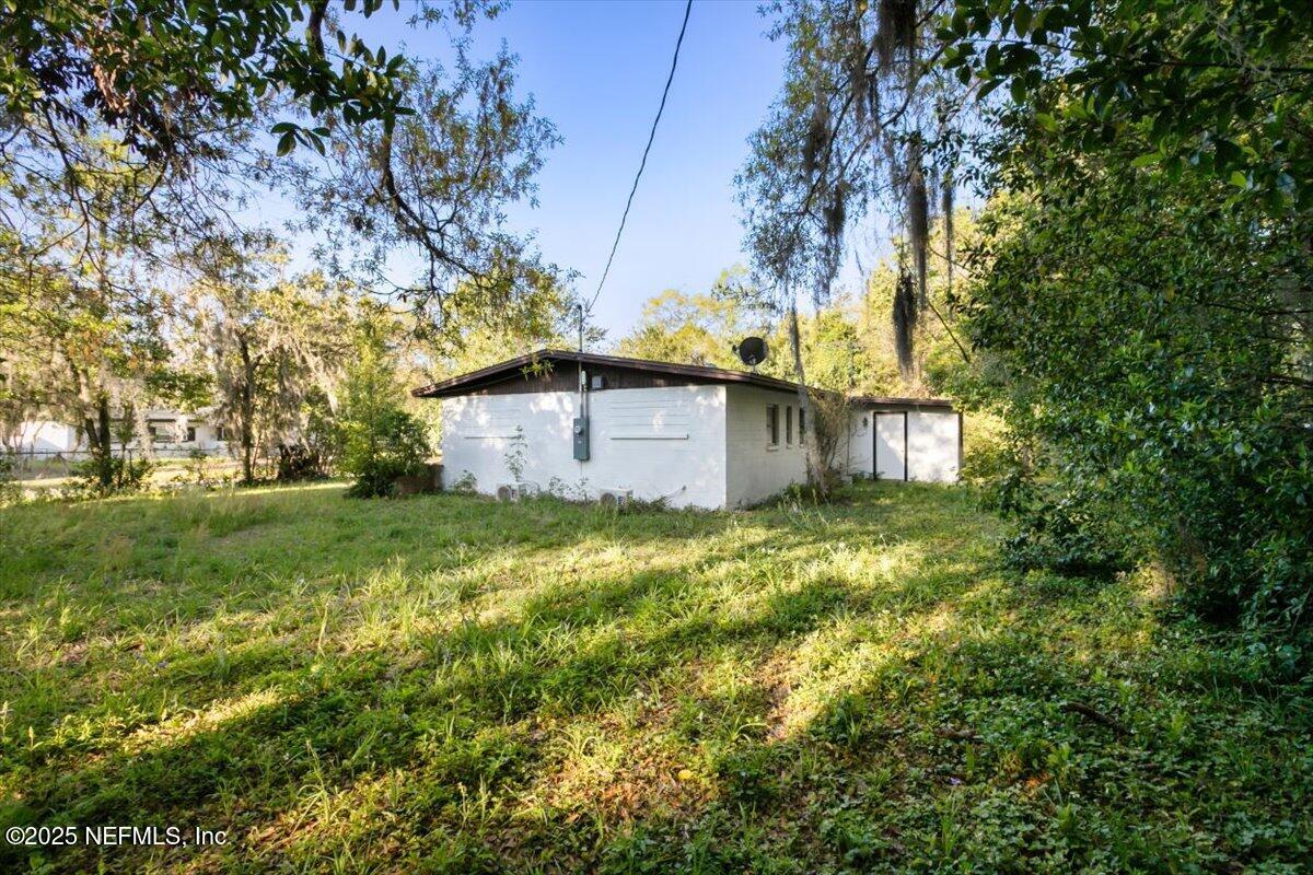 7567 Strato Road Jacksonville, FL 32210 - Photo 4 of 26 a backyard of a house with lots of green space