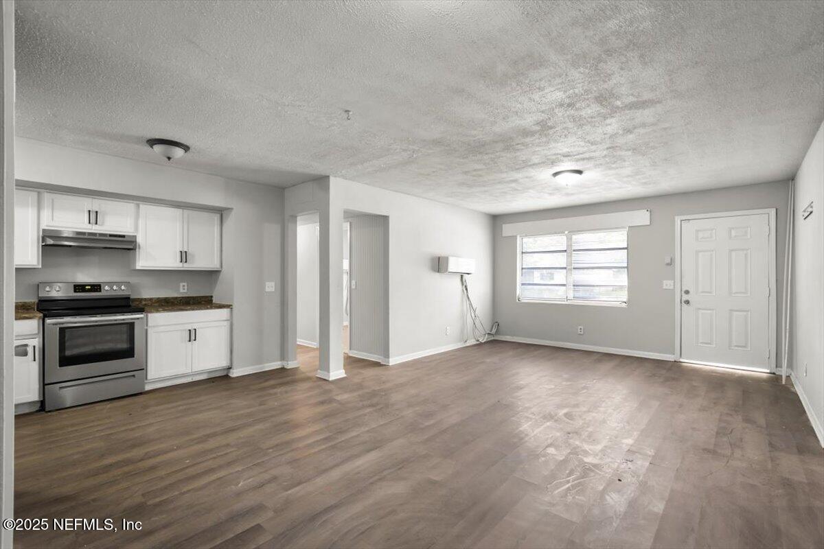 7567 Strato Road Jacksonville, FL 32210 - Photo 7 of 26 a view of a kitchen with a stove cabinets and a window