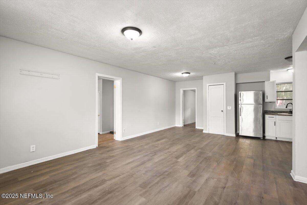 7567 Strato Road Jacksonville, FL 32210 - Photo 10 of 26 a view of empty room with wooden floor