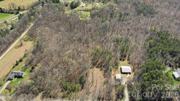 a bird view of a house with a yard and lake view