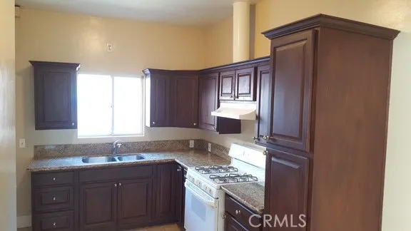 1060 Cherry Long Beach, CA 90813 - Photo 8 of 63 a kitchen with granite countertop a sink cabinets stainless steel appliances and a window