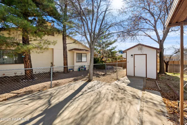 a large tree in front of a house