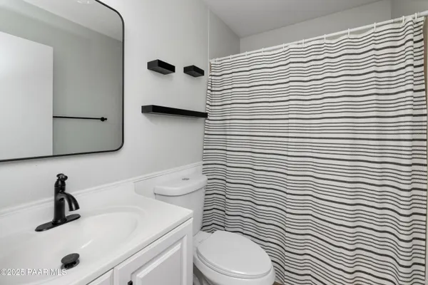 a bathroom with a sink a toilet and mirror