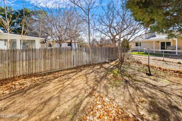 a backyard of a house with a large tree