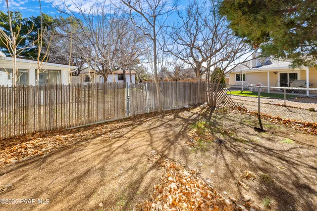 a backyard of a house with a large tree