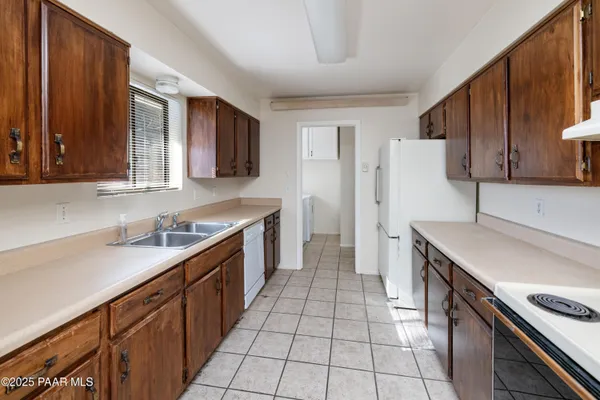 a kitchen with a sink stove and refrigerator