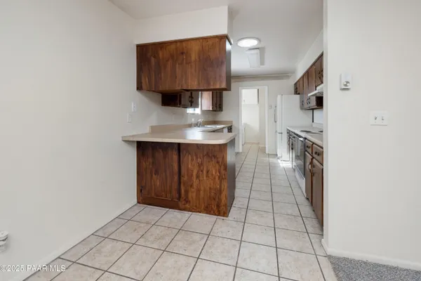 a kitchen with stainless steel appliances a sink stove and cabinets
