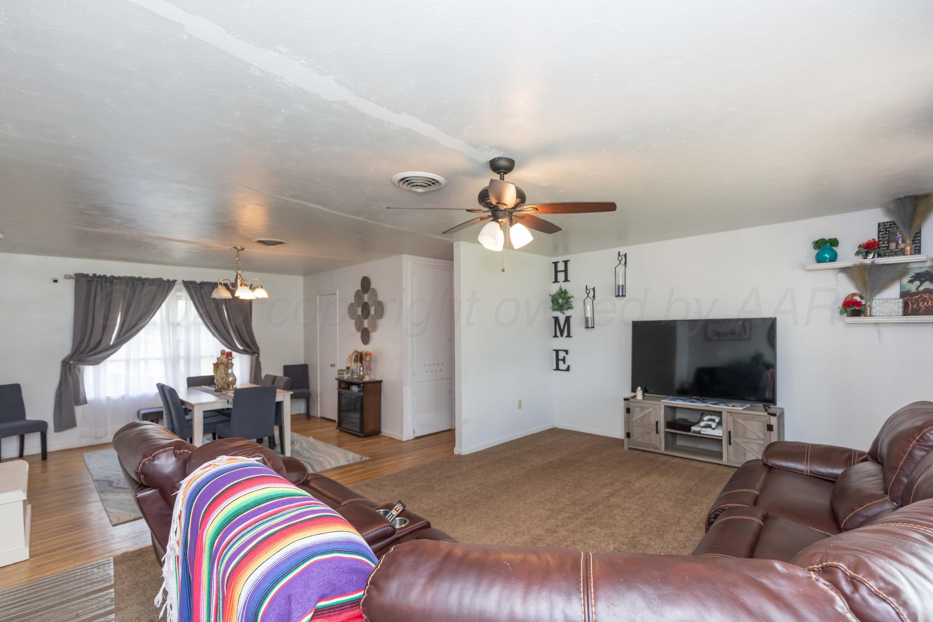 501 Southeast 2nd Street Tulia, TX 79088 - Photo 3 of 32 a living room with furniture and a flat screen tv