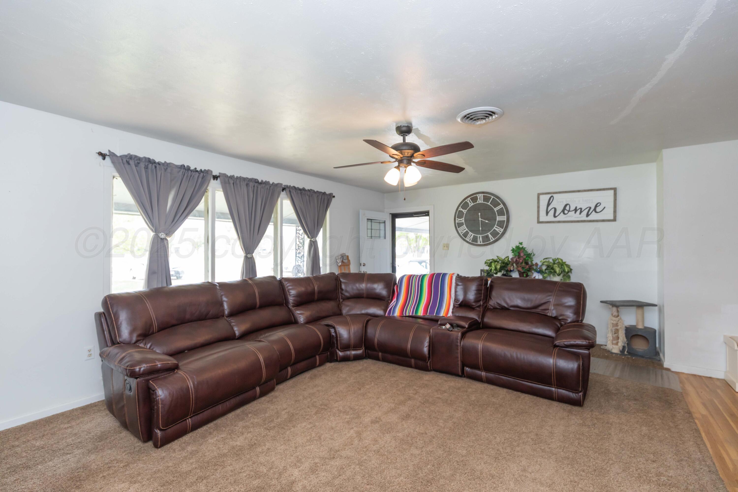 501 Southeast 2nd Street Tulia, TX 79088 - Photo 6 of 32 a living room with furniture and a large window