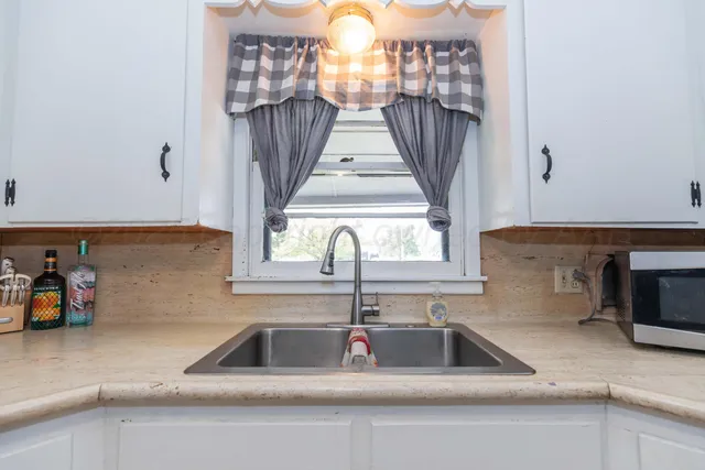 a kitchen with a sink and a window