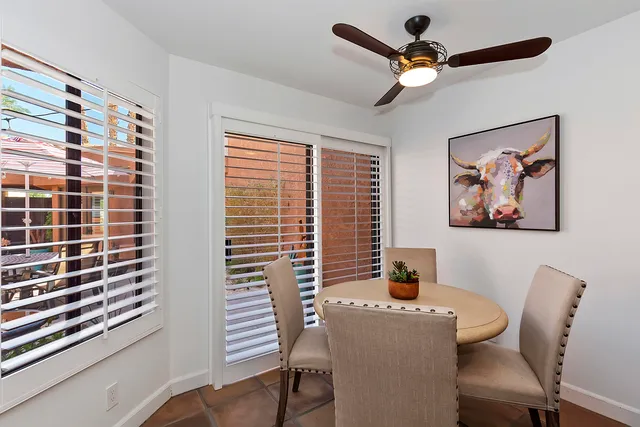 a dining room with furniture and a window