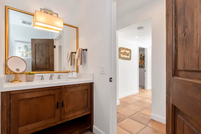 a bathroom with a double vanity sink mirror and