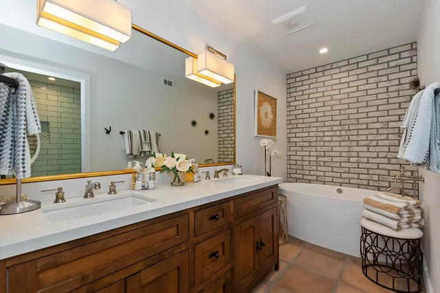 a bathroom with a sink double vanity and a shower