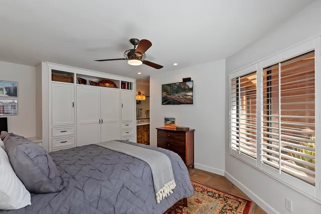 a bedroom with a large bed and a window