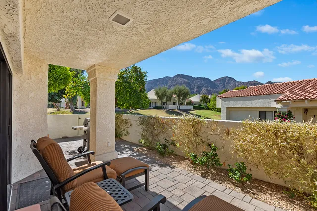 a view of a patio with chair and tables