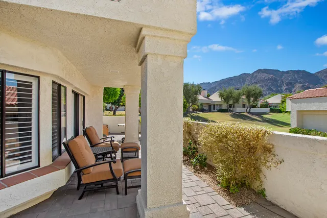 a view of a terrace with a table and chairs