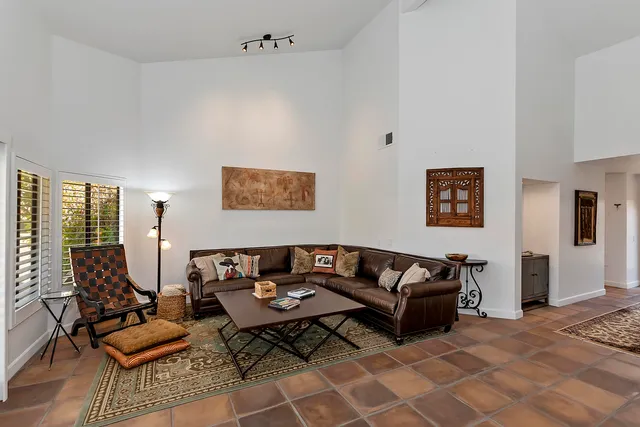 a living room with furniture rug and window