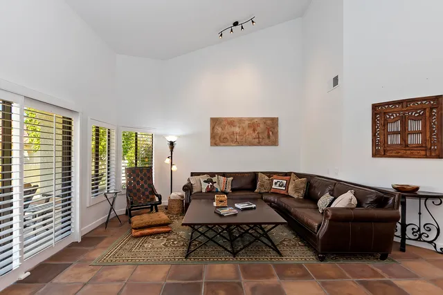 a living room with furniture and a floor to ceiling window