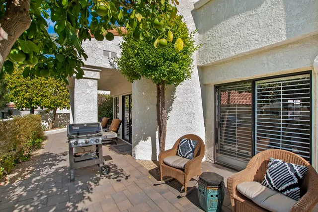 a house view with a sitting space and garden