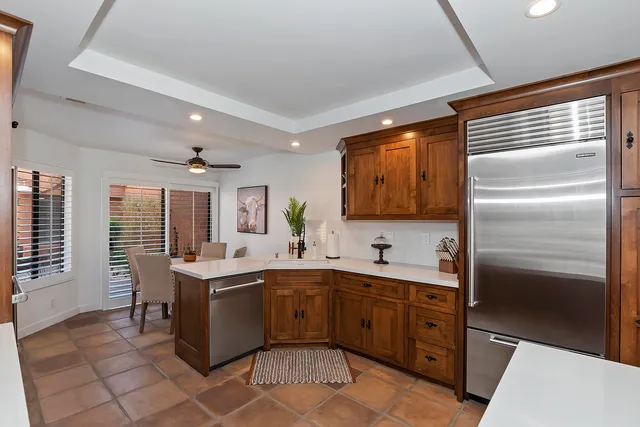 a kitchen with a sink stainless steel appliances and cabinets