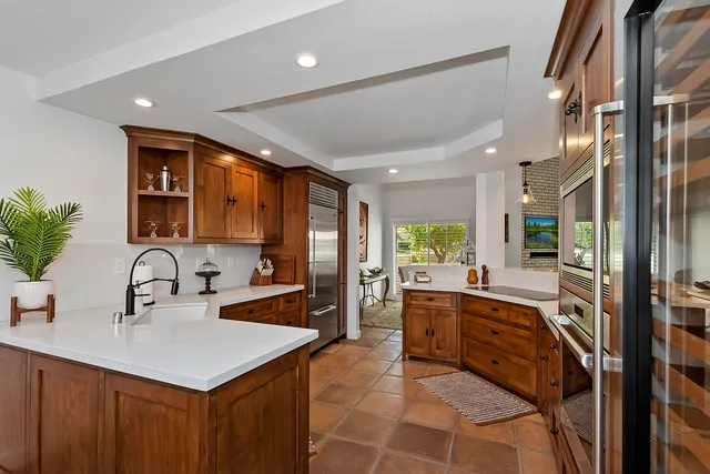 a large kitchen with kitchen island a sink stainless steel appliances and cabinets