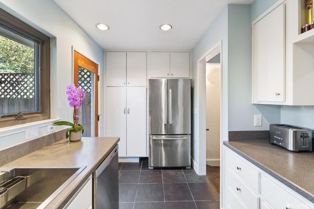 a kitchen with stainless steel appliances a refrigerator sink and cabinets
