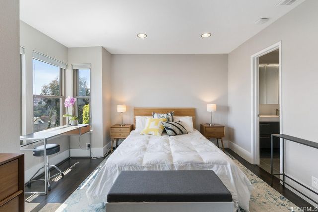 a bed room with a bed and a large window