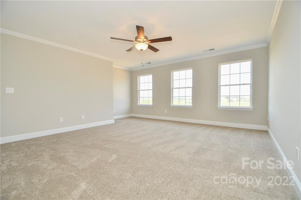5413 Austin Road, Unit 4 Monroe, NC 28112 - Photo 13 of 22 an empty room with windows and ceiling fan view