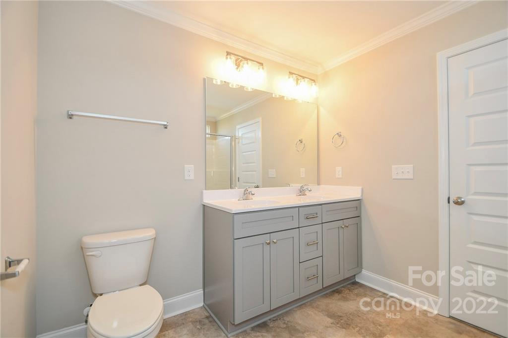 5413 Austin Road, Unit 4 Monroe, NC 28112 - Photo 15 of 22 a bathroom with a toilet sink and mirror