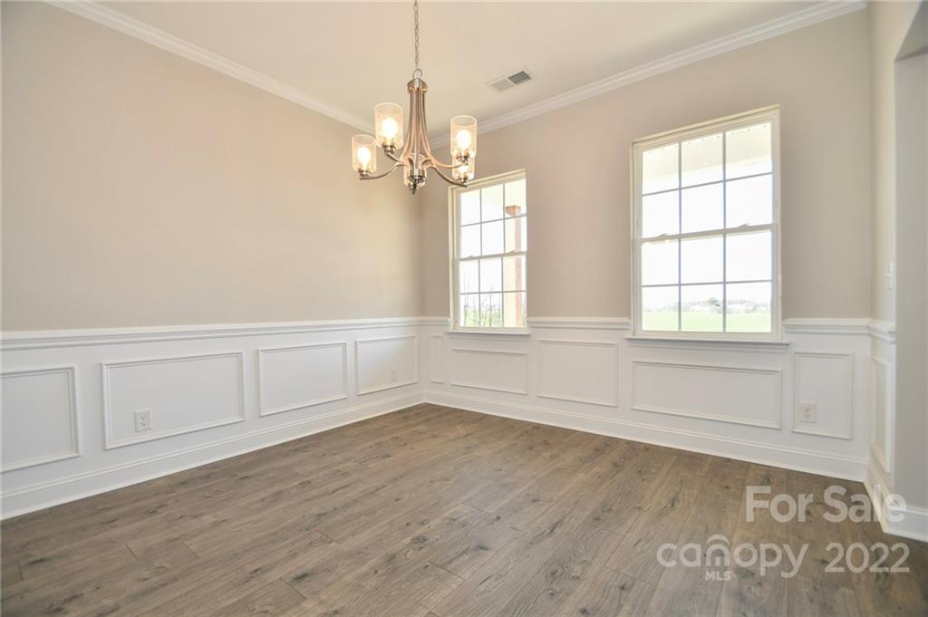 5413 Austin Road, Unit 4 Monroe, NC 28112 - Photo 4 of 22 wooden floor in an empty room with a window