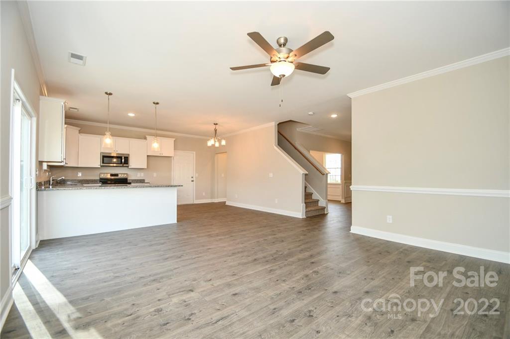 5413 Austin Road, Unit 4 Monroe, NC 28112 - Photo 8 of 22 a view of a kitchen with a sink and dishwasher a refrigerator with wooden floor