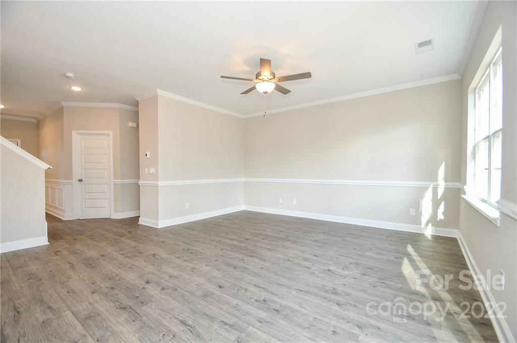 5413 Austin Road, Unit 4 Monroe, NC 28112 - Photo 9 of 22 wooden floor in an empty room with a window