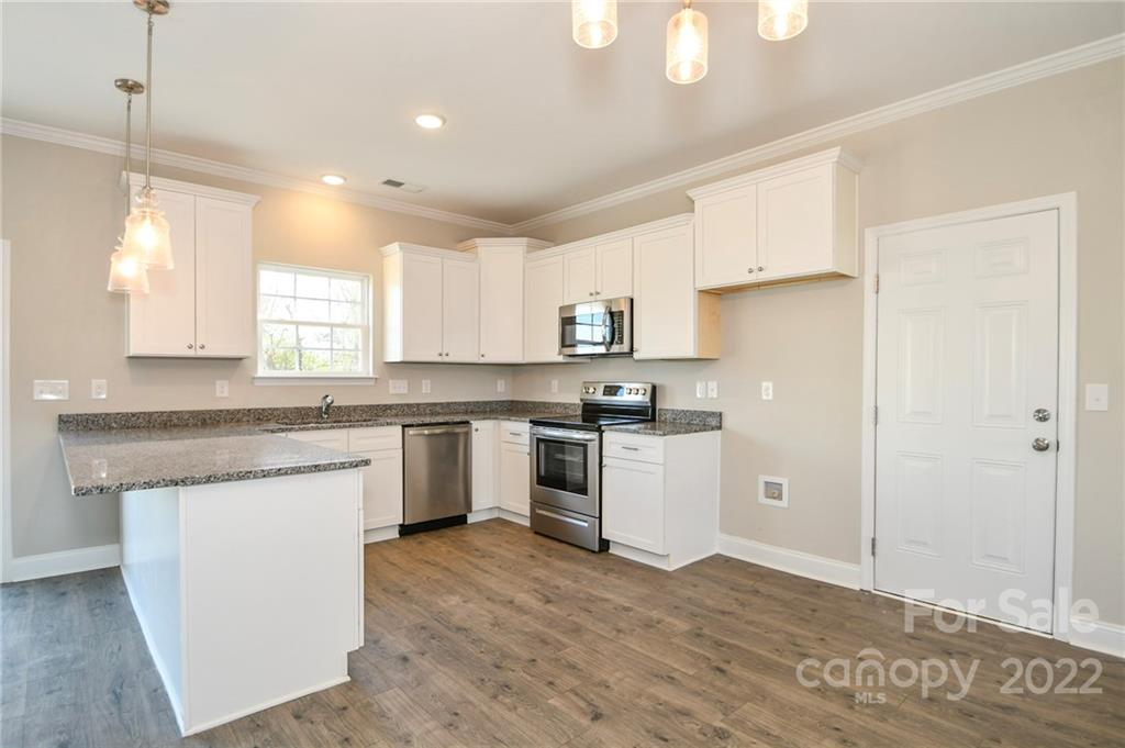 5413 Austin Road, Unit 4 Monroe, NC 28112 - Photo 10 of 22 a kitchen with granite countertop white cabinets and white appliances