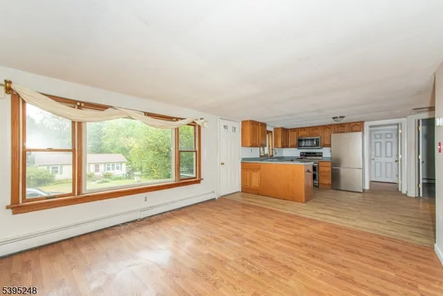 a view of kitchen with furniture and wooden floor