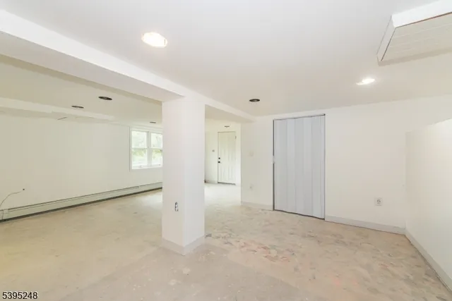 an empty room with windows and closet