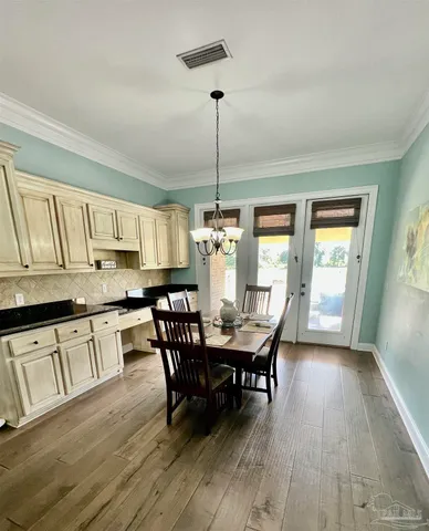 a view of a room that has a door and wooden floor