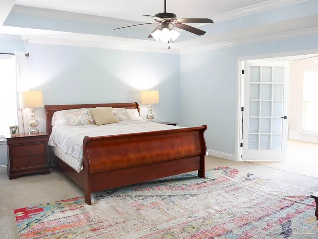 a view of a bedroom with a bed and a chandelier