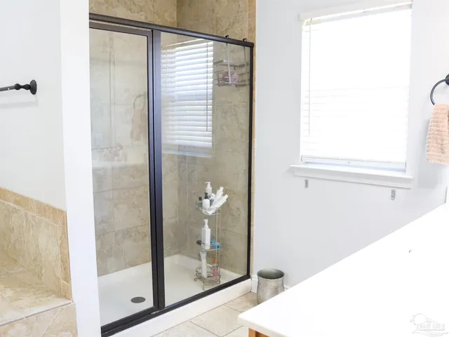 a bedroom with a large bed and a window