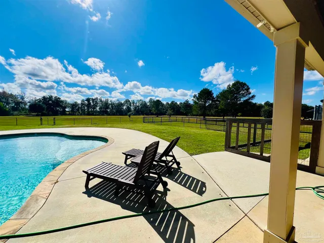 a view of swimming pool with lounge chair